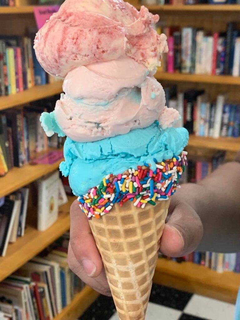 three scoops of ice cream on a waffle cone